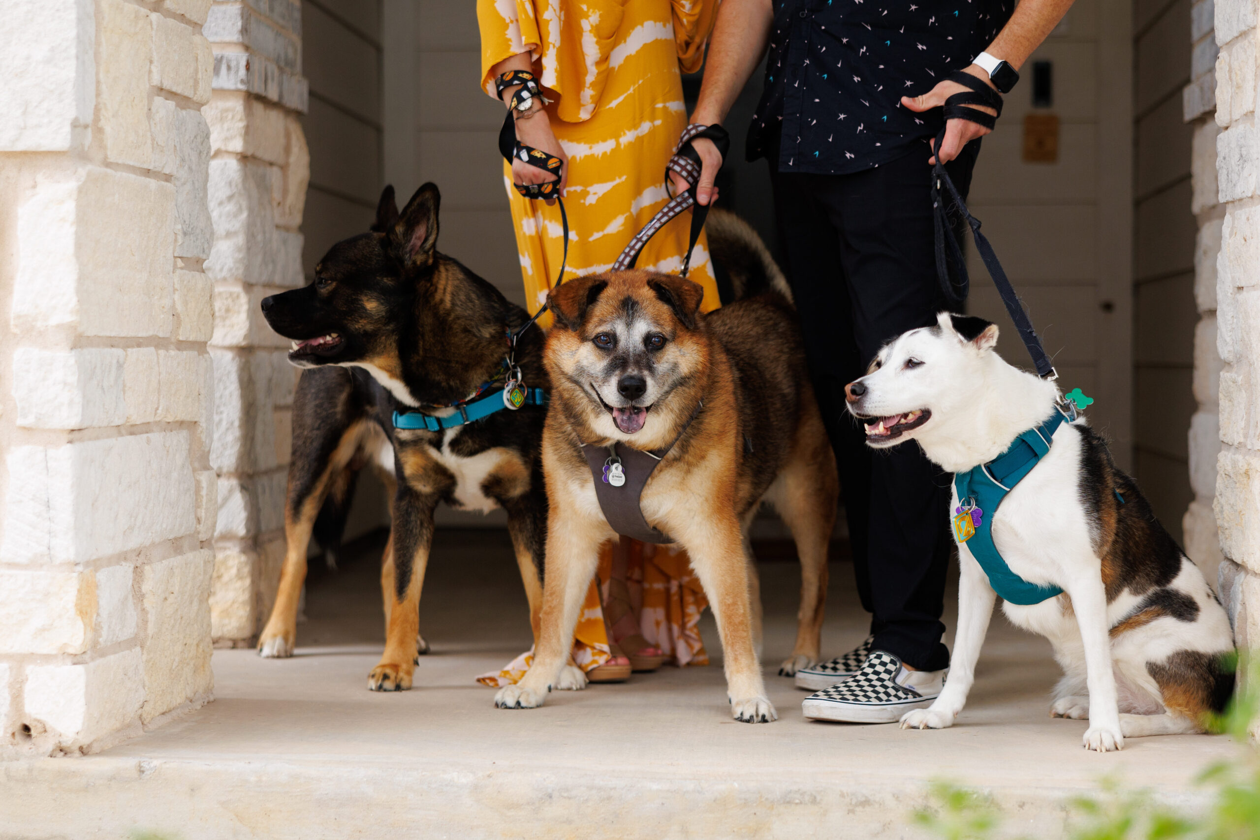 Deacon, Chloe, and Sebastián on our front porch with us standing behind them.
